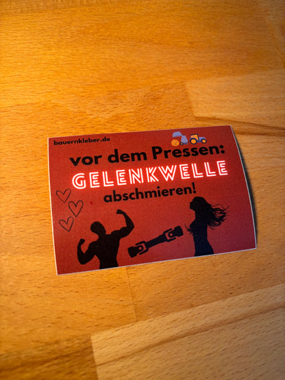 Sticker " Vor dem Pressen Gelenkwelle abschmieren"